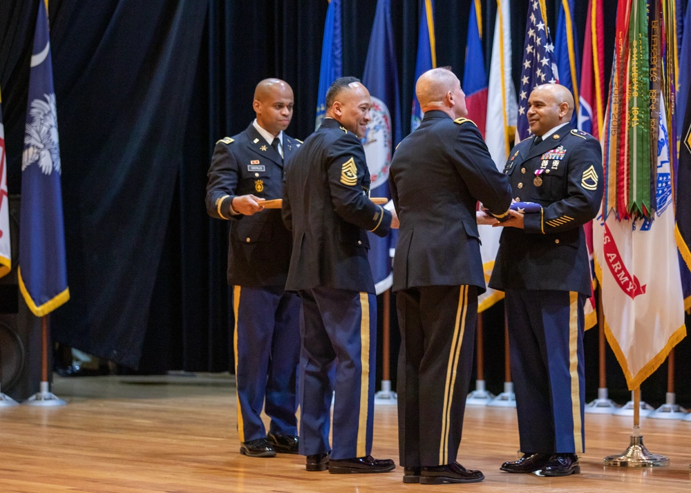 Fort Knox Holds Monthly Retirement Ceremony on June 27 in Honor of Service Members 2 Honoree receiving flag and commendation
